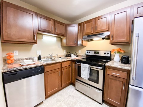 a kitchen with stainless steel appliances and wooden cabinets